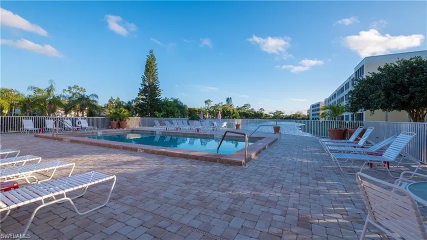Community pool facing the beautiful lake and featuring a patio