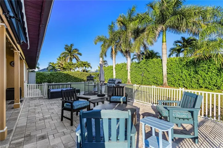View of patio with outdoor lounge area and grilling area