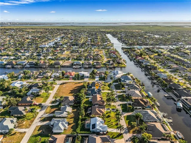 Aerial overview of property's location featuring nearby suburban area and a large body of water