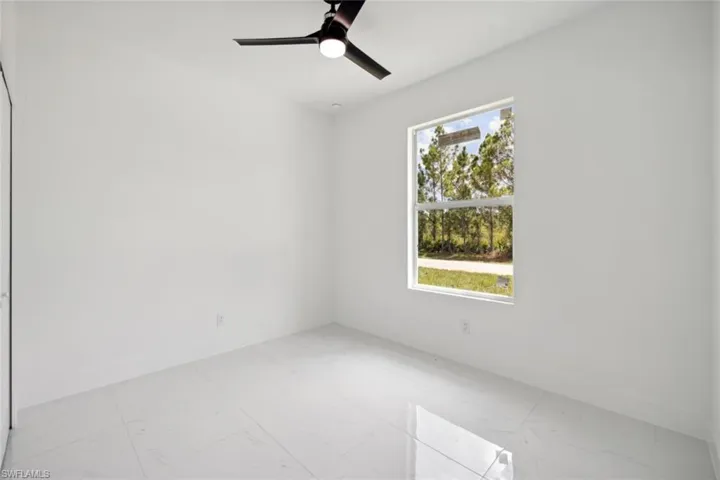 Spare room featuring plenty of natural light and ceiling fan