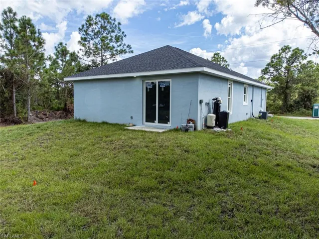 Back of property with a yard
