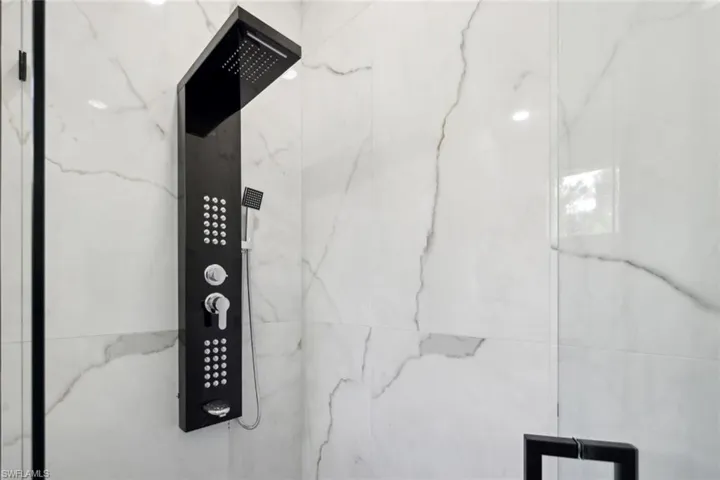 Room details with tiled shower