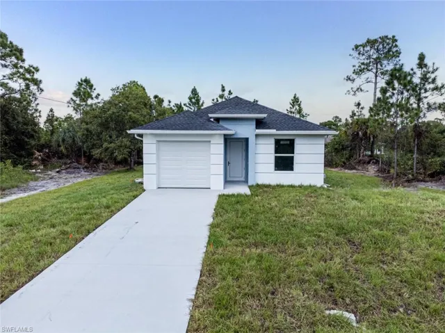 View of front facade with a front lawn and a garage