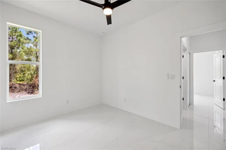 Empty room featuring ceiling fan