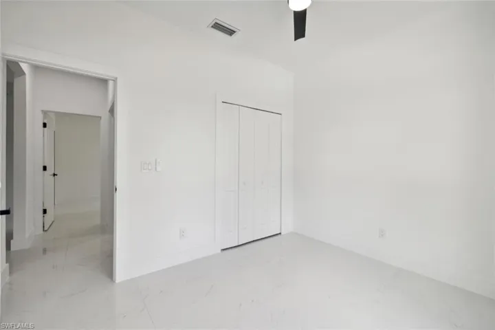 Unfurnished bedroom with a closet and ceiling fan