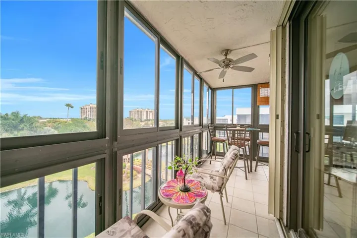 Sunroom / solarium featuring floor to ceiling windows, a city view, and tile patterned floors