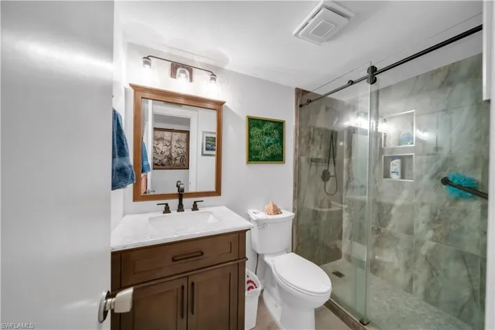 Bathroom with vanity and a shower stall