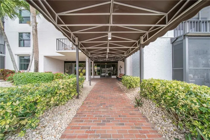 Property entrance with stucco siding and a patio area