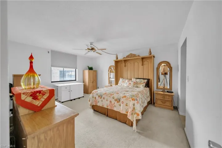 Bedroom with light colored carpet and ceiling fan