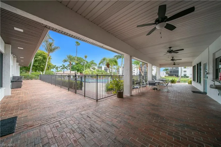 View of patio / terrace with ceiling fan, outdoor dining space, and a community pool