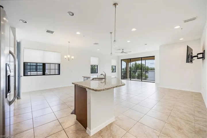 Kitchen featuring pendant lighting, light Stone Countertops and Large Island