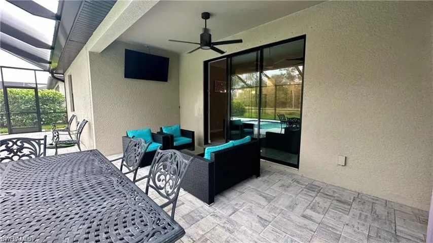 View of patio with ceiling fan, an outdoor hangout area, and a lanai