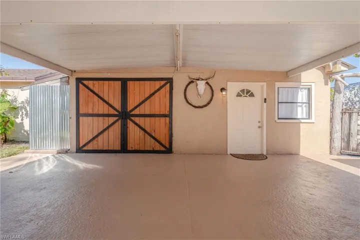 Carport area and entrances to detached building
