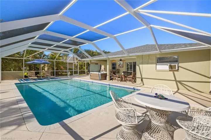 Pool featuring a patio area, a lanai, outdoor dining space, and ceiling fan
