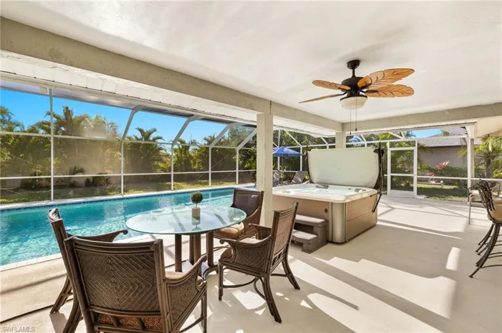 Sunroom with a healthy amount of sunlight and a ceiling fan