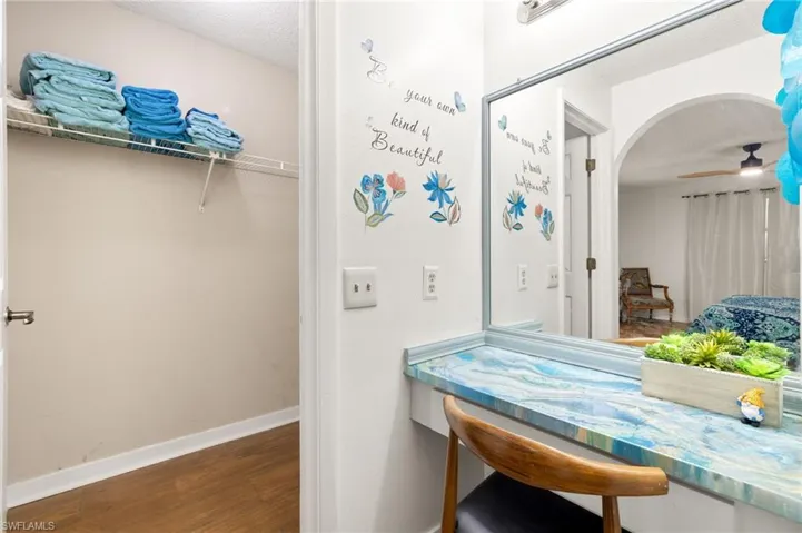 Bathroom with ceiling fan, baseboards, and wood finished floors
