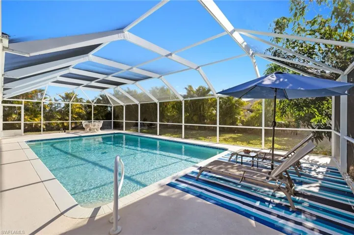 Outdoor pool with a lanai and a patio