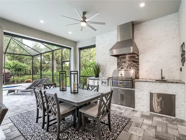 Tiled dining area featuring sink and ceiling fan