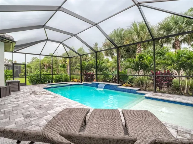 View of pool featuring a patio, pool water feature, and a lanai