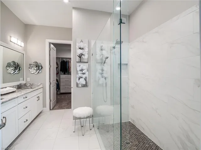 Bathroom with vanity, tile patterned flooring, and walk in shower
