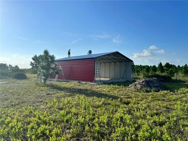 View of outbuilding with a carport