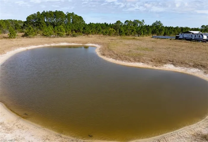 Water view with a heavily wooded area