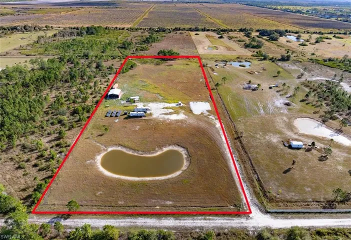 Aerial view of sparsely populated area with property parcel outlined