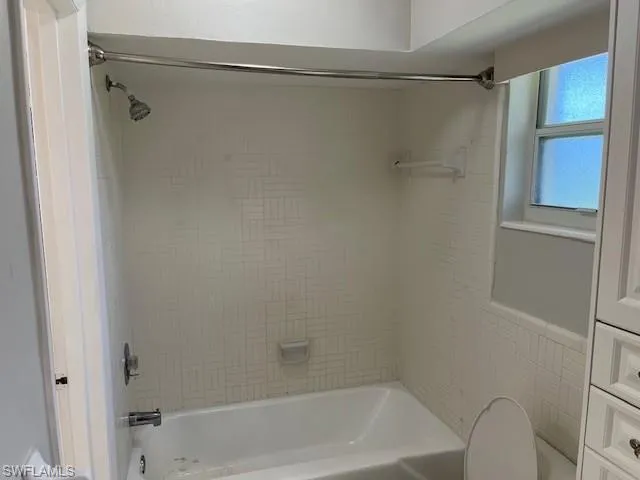 Bathroom featuring washtub / shower combination