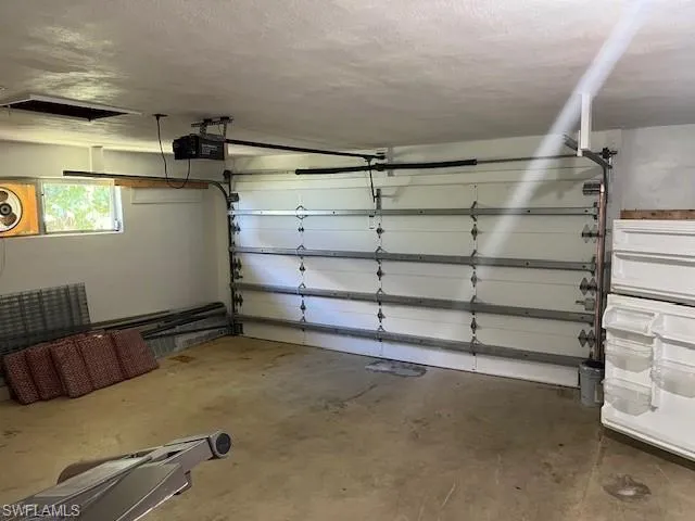 Garage featuring a garage door opener