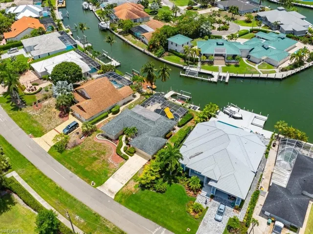 Aerial view of residential area featuring a nearby body of water