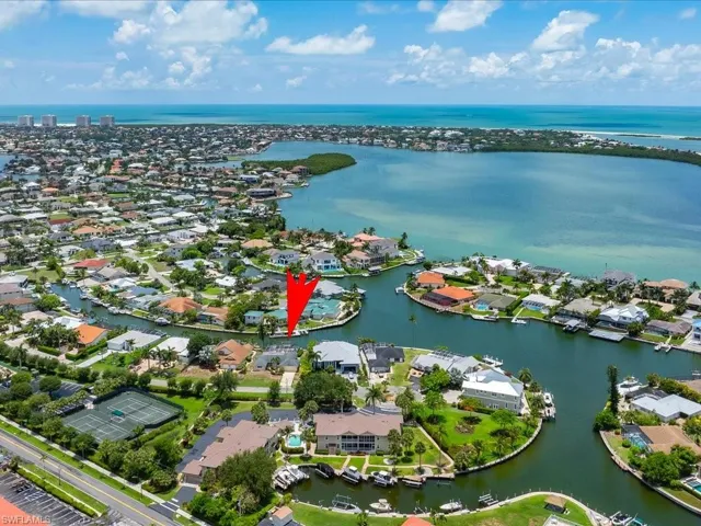 Aerial perspective of suburban area with a large body of water