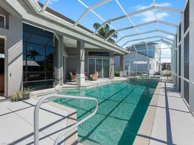 View of swimming pool with a patio area, a lanai, and a pool with connected hot tub