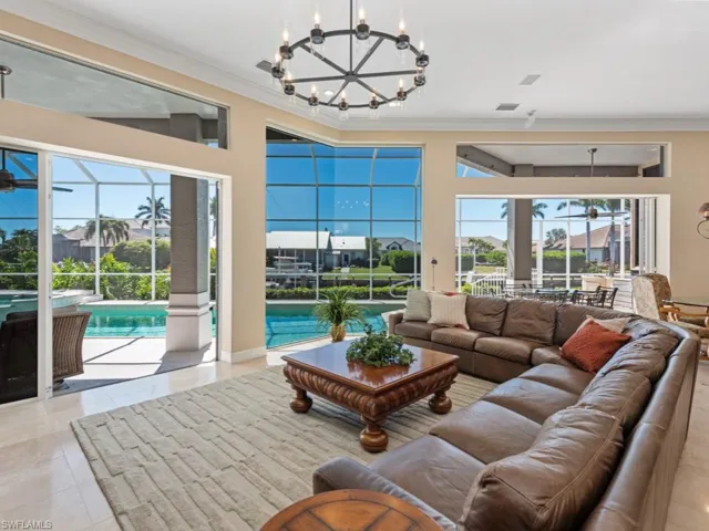 Tiled living area featuring visible vents, a sunroom, and ornamental molding