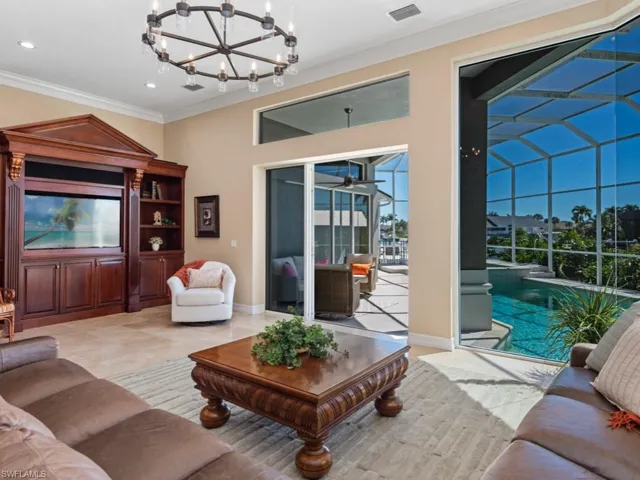 Living room featuring visible vents, ornamental molding, recessed lighting, a sunroom, and baseboards