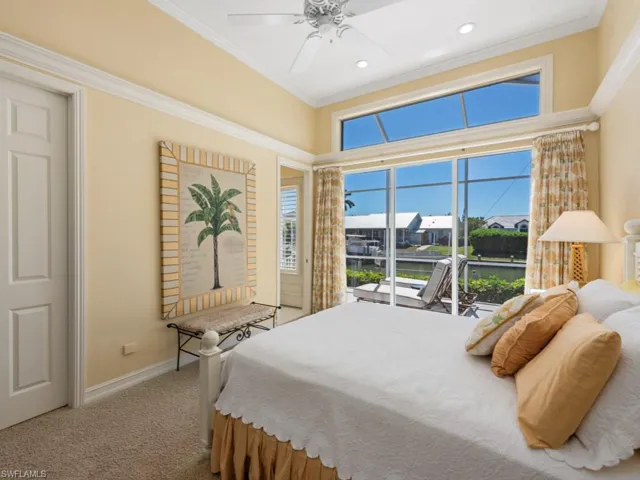 Carpeted bedroom featuring ceiling fan, recessed lighting, baseboards, and ornamental molding