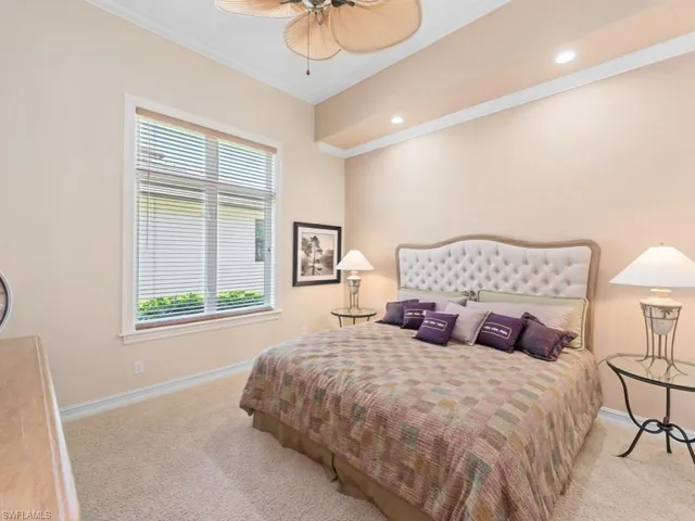 Carpeted bedroom featuring recessed lighting, baseboards, and ornamental molding
