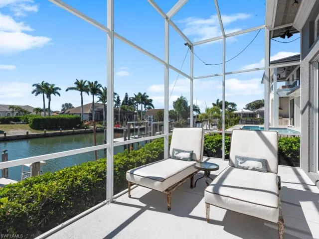Sunroom featuring a water view