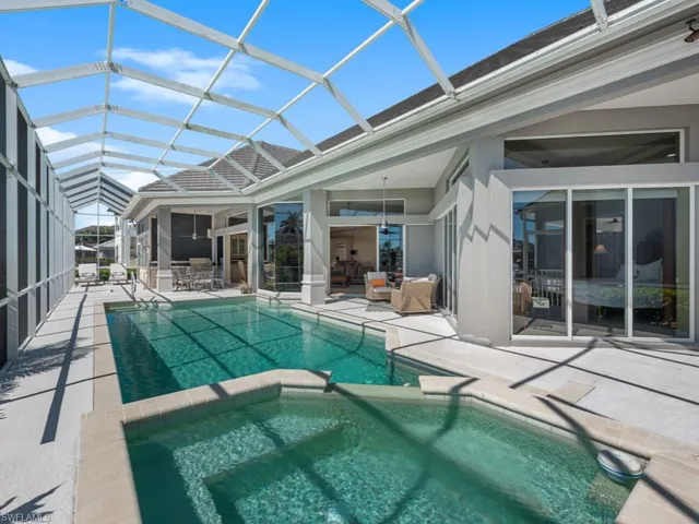 View of swimming pool featuring a patio area, a lanai, and a pool with connected hot tub