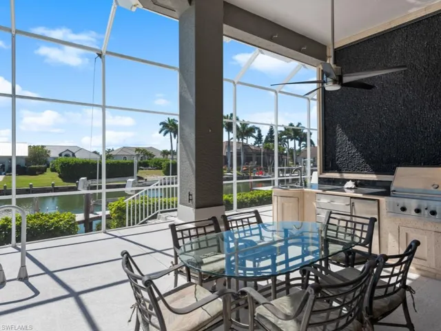 View of patio / terrace featuring outdoor dining space, a lanai, grilling area, and an outdoor kitchen