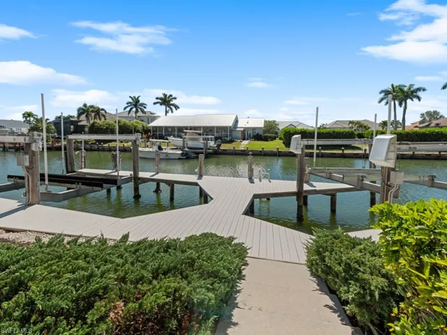View of dock featuring a residential view, a water view, and boat lift