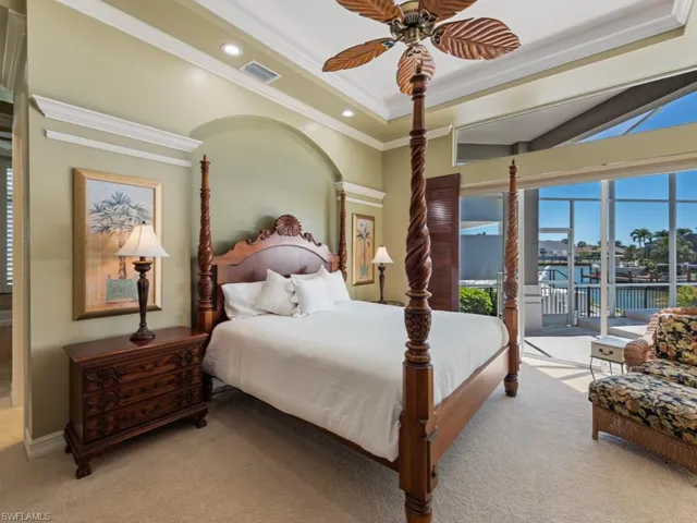 Carpeted bedroom featuring visible vents, ornamental molding, recessed lighting, a raised ceiling, and access to outside