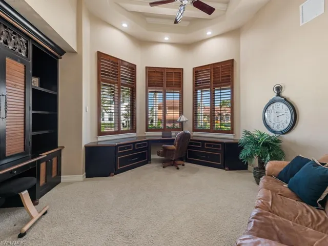 Office area featuring visible vents, carpet floors, built in study area, recessed lighting, and a towering ceiling