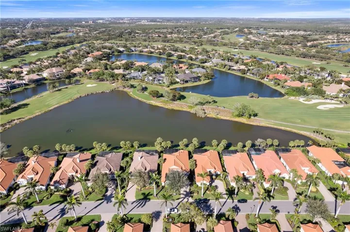 Drone / aerial view featuring a water view, a residential view, and golf course view