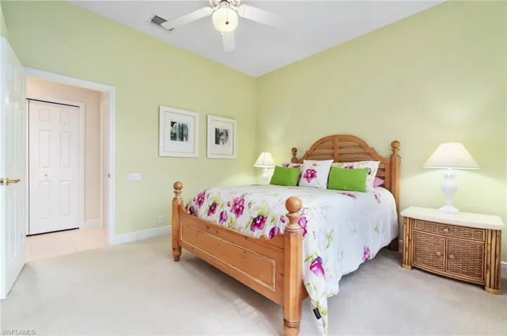 Bedroom with a ceiling fan, carpet flooring, visible vents, and baseboards