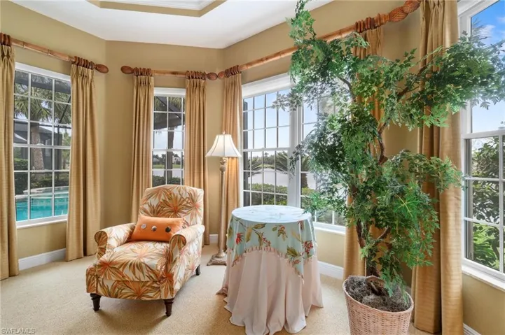 Living area featuring carpet floors and baseboards