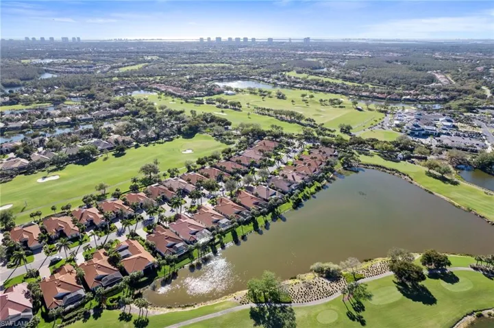Aerial view with a residential view, view of golf course, and a water view