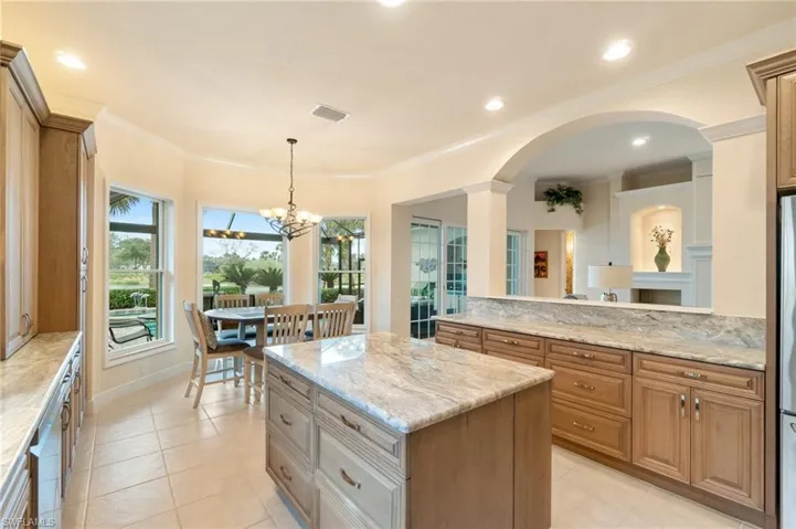 Kitchen featuring ornamental molding, visible vents, a kitchen island, and light tile patterned flooring