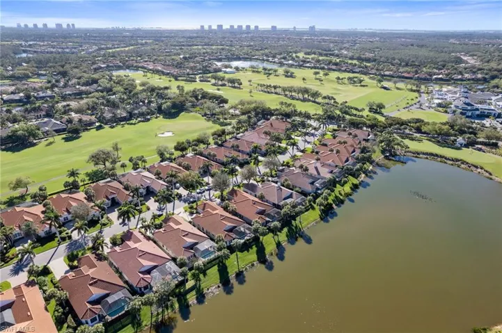 Bird's eye view with a water view, view of golf course, and a residential view