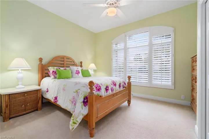 Bedroom featuring carpet, baseboards, and ceiling fan