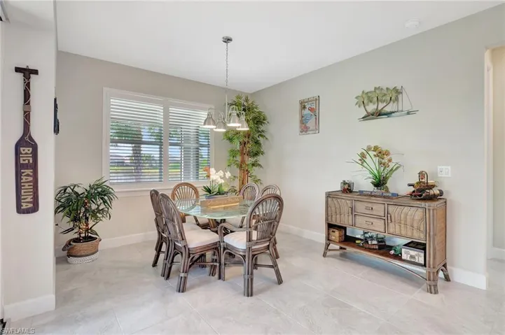 Tiled dining room with a notable chandelier